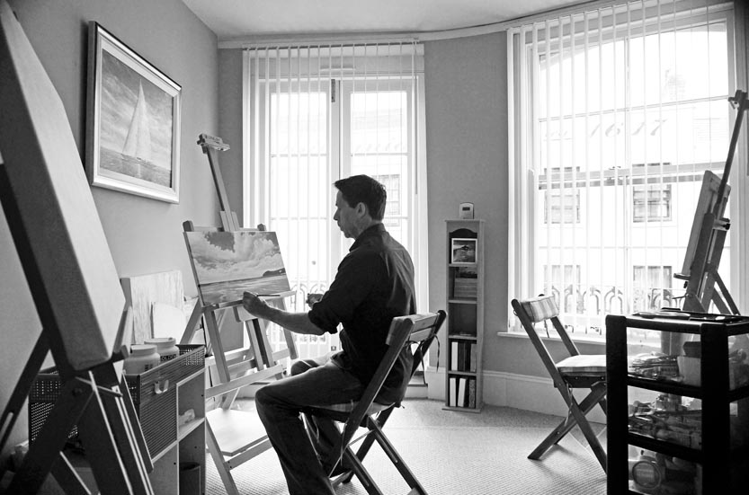 artist Mark Woollacott painting in his studio with three Loxley Essex Studio easels